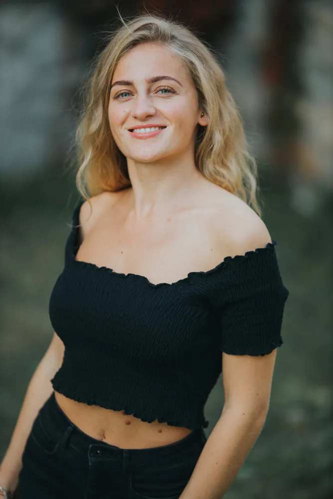 A woman wearing a black top and black jeans.